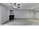 Spacious living room featuring a fireplace, ceiling fan, and sleek gray wood flooring at 3154 Panthers Trce, Decatur, GA 30034