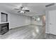 Open living room with a fireplace, ceiling fan, and stylish pendant lighting at 3154 Panthers Trce, Decatur, GA 30034