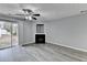 Spacious living room with luxury vinyl plank flooring, fan, fireplace, and sliding glass doors to outdoor space at 3154 Panthers Trce, Decatur, GA 30034