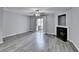 Spacious living room with luxury vinyl plank flooring, fan, fireplace, and sliding glass doors to outdoor space at 3154 Panthers Trce, Decatur, GA 30034