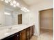 Bathroom with a double sink vanity, a large mirror, and an adjacent room for additional space or storage at 563 Carleton Pl, Locust Grove, GA 30248