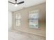 Bright bedroom with a ceiling fan and large windows, offering ample natural light at 563 Carleton Pl, Locust Grove, GA 30248