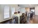 Dining area with hardwood floors, wooden table and chairs, near the kitchen and with access to the screened porch at 563 Carleton Pl, Locust Grove, GA 30248