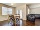 Bright dining area with a wood table set, wainscoting, and dark hardwood floors at 563 Carleton Pl, Locust Grove, GA 30248