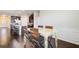 Spacious dining area with hardwood floors, wooden table and chairs, and a view of the kitchen and living area at 563 Carleton Pl, Locust Grove, GA 30248