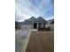 View of the home with brick and siding, an attached two car garage, and driveway at 563 Carleton Pl, Locust Grove, GA 30248