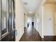 Long hallway with hardwood floors, white trim, and views into other rooms at 563 Carleton Pl, Locust Grove, GA 30248