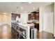 Modern kitchen with granite countertops, stainless steel appliances, and dark wood cabinetry with barstool seating at 563 Carleton Pl, Locust Grove, GA 30248