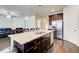 Kitchen island with granite countertop, stainless steel appliances, and barstool seating at 563 Carleton Pl, Locust Grove, GA 30248