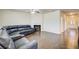 Spacious living room featuring a dark sectional couch, fireplace, and hardwood floors at 563 Carleton Pl, Locust Grove, GA 30248