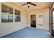 Enclosed porch with ceiling fan, string lights, and access to the home's interior, perfect for outdoor relaxation at 563 Carleton Pl, Locust Grove, GA 30248