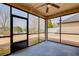 Enclosed porch with string lights, offering scenic outdoor views of the lawn and backyard at 563 Carleton Pl, Locust Grove, GA 30248