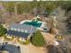 Aerial view of neighborhood clubhouse with pool, playground, tennis courts and mature trees at 313 Revolution Dr, Peachtree City, GA 30269