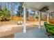 Inviting backyard patio with a brick basketball court, covered seating area, and serene wooded views at 313 Revolution Dr, Peachtree City, GA 30269