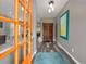 Bright foyer featuring stylish gray walls, wood-look floors, and a vibrant orange front door at 313 Revolution Dr, Peachtree City, GA 30269