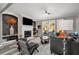 Open-concept living room with fireplace, gray walls, wood floors, and plenty of natural light at 313 Revolution Dr, Peachtree City, GA 30269