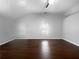 Spacious bedroom with dark laminate wood flooring and a small window at 318 Kelly Se St, Atlanta, GA 30312