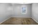 A vacant bedroom with light colored walls, carpet, and a large window at 318 Kelly Se St, Atlanta, GA 30312