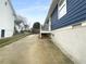 Exterior view of a blue home with a concrete driveway and limited landscaping at 318 Kelly Se St, Atlanta, GA 30312