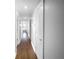 Long hallway with hardwood floors and white doors leading to various rooms at 318 Kelly Se St, Atlanta, GA 30312