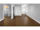 Spacious living room with hardwood floors and stainless steel refrigerator in the background at 318 Kelly Se St, Atlanta, GA 30312