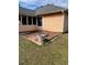 A brick back patio with potted plants, and a back view of a peach colored house at 355 Tait Rd, Stockbridge, GA 30281