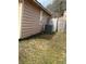 A view of the side and backyard featuring grass and an AC unit at 355 Tait Rd, Stockbridge, GA 30281