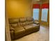 Cozy bedroom with tan sofa, two windows, and neutral carpet at 355 Tait Rd, Stockbridge, GA 30281