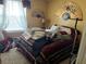 Cozy bedroom featuring a comfortable bed, decorative fans, and natural light from the window at 355 Tait Rd, Stockbridge, GA 30281