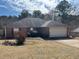 Charming brick home featuring a well-maintained front yard and attached garage at 355 Tait Rd, Stockbridge, GA 30281