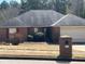 Charming brick home featuring a well-maintained front yard and attached garage at 355 Tait Rd, Stockbridge, GA 30281