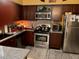 This L-shaped kitchen has stainless steel appliances and granite countertops at 355 Tait Rd, Stockbridge, GA 30281