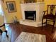 Living room view featuring a white painted brick fireplace and dark wood floors at 355 Tait Rd, Stockbridge, GA 30281