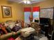 Inviting living room featuring a sofa, patterned pillows, workspace, and natural light at 355 Tait Rd, Stockbridge, GA 30281