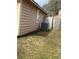 Landscaped side yard with an air conditioning unit and wood fence at 355 Tait Rd, Stockbridge, GA 30281