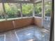 Enclosed sunroom with tiled floor and screened windows offering tranquil outdoor views at 355 Tait Rd, Stockbridge, GA 30281