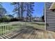 Enjoy the large backyard from the home's wooden back deck with white railing at 3736 Rainbow Cir, Snellville, GA 30039