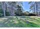 Grassy backyard is surrounded by mature trees providing privacy at 3736 Rainbow Cir, Snellville, GA 30039