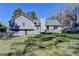 View of the house with a deck and fenced-in backyard shaded by trees at 3736 Rainbow Cir, Snellville, GA 30039