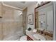 Modern bathroom featuring a tiled shower with glass door, granite countertop, and decorative accent tiles at 3736 Rainbow Cir, Snellville, GA 30039