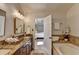 A bright bathroom with granite counters, double sinks, and tile flooring at 3736 Rainbow Cir, Snellville, GA 30039