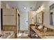 A view of the main bathroom with double sinks, granite countertops, and tile flooring at 3736 Rainbow Cir, Snellville, GA 30039