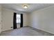 Bedroom with carpeted floor, textured ceiling, and a window for natural light, painted in neutral colors at 3736 Rainbow Cir, Snellville, GA 30039