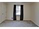 This bedroom boasts neutral paint, a carpeted floor, and a window allowing plenty of light, creating a cozy ambiance at 3736 Rainbow Cir, Snellville, GA 30039