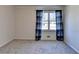 This bedroom features neutral walls, carpet, and window with blue plaid curtains allowing lots of natural light at 3736 Rainbow Cir, Snellville, GA 30039