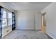 This bedroom has a neutral wall paint, carpeted floor, a window for natural light, and a white painted door at 3736 Rainbow Cir, Snellville, GA 30039