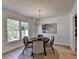 Inviting dining room featuring a round table, chandelier, and a large window for natural light at 3736 Rainbow Cir, Snellville, GA 30039