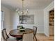 Dining area with chandelier, light-colored walls, and hardwood floors in a bright, inviting space at 3736 Rainbow Cir, Snellville, GA 30039