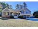 Charming two-story home featuring a brick and gray siding exterior, well-manicured lawn, and a two-car garage at 3736 Rainbow Cir, Snellville, GA 30039