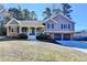 Charming two-story home featuring a brick and gray siding exterior, well-manicured lawn, and a two-car garage at 3736 Rainbow Cir, Snellville, GA 30039